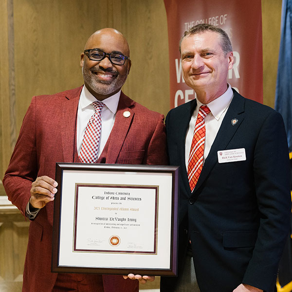 Shontrai Irving poses with Rick Van Kooten at Irving's awards ceremony.